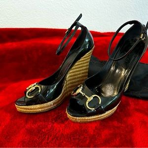 Guccis black patent wedges